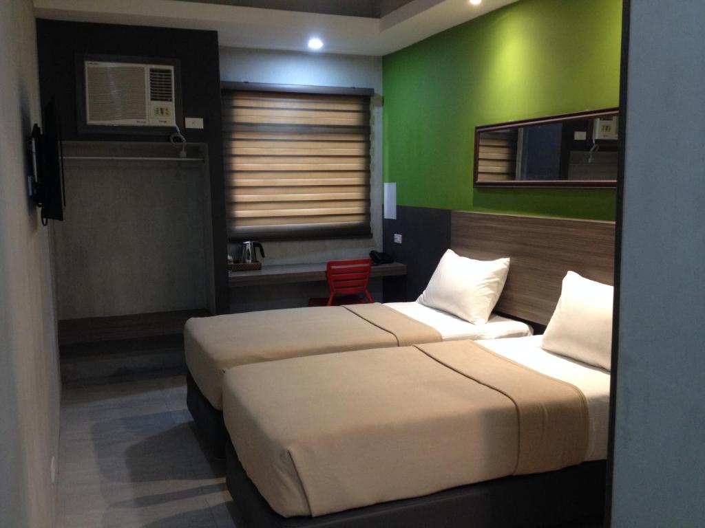Postel nebo postele na pokoji v ubytování Express Inn Cebu Osmena