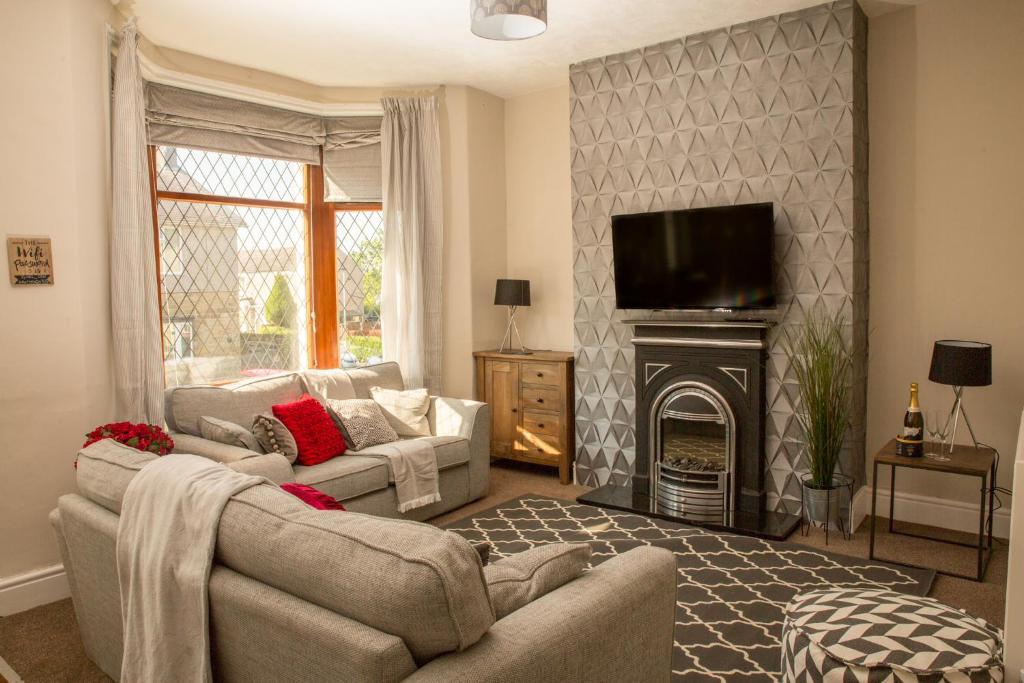 a living room with two couches and a fireplace at Marsden Lodge in Nelson