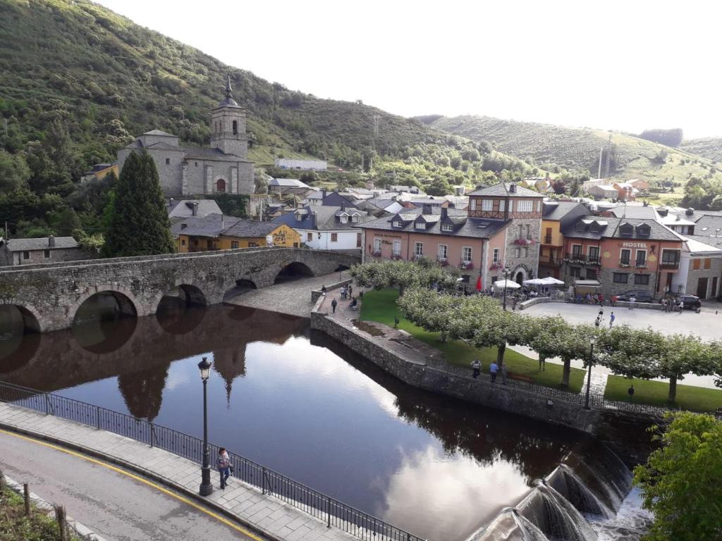 a bridge over a river next to a town at Camino Real in Molinaseca