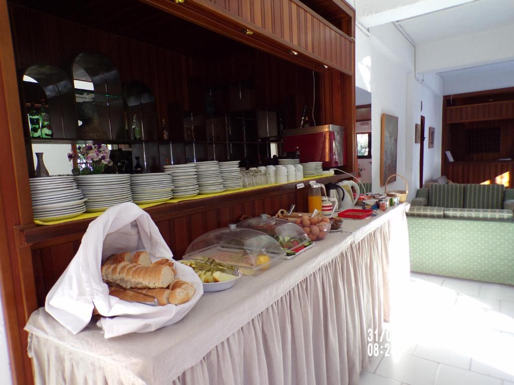 ein Buffet mit Brot und anderen Speisen darauf in der Unterkunft Sunlight Hotel in Agia Galini
