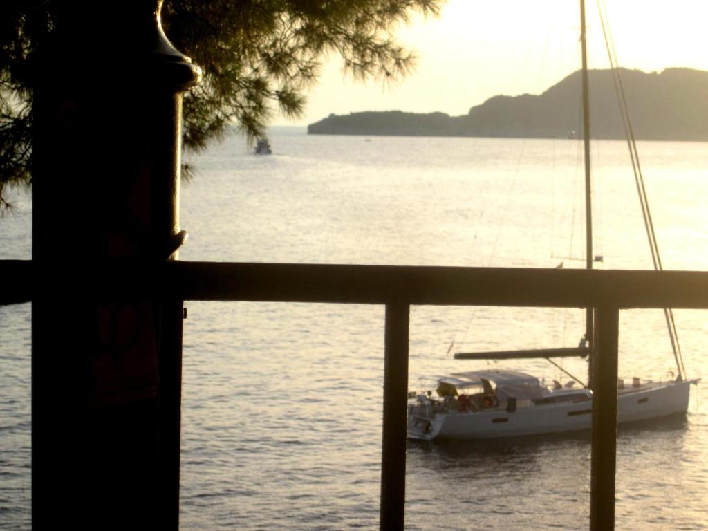 a sailboat in the water with a view from a window at Apartments Danilo Kažanegra in Sveti Stefan