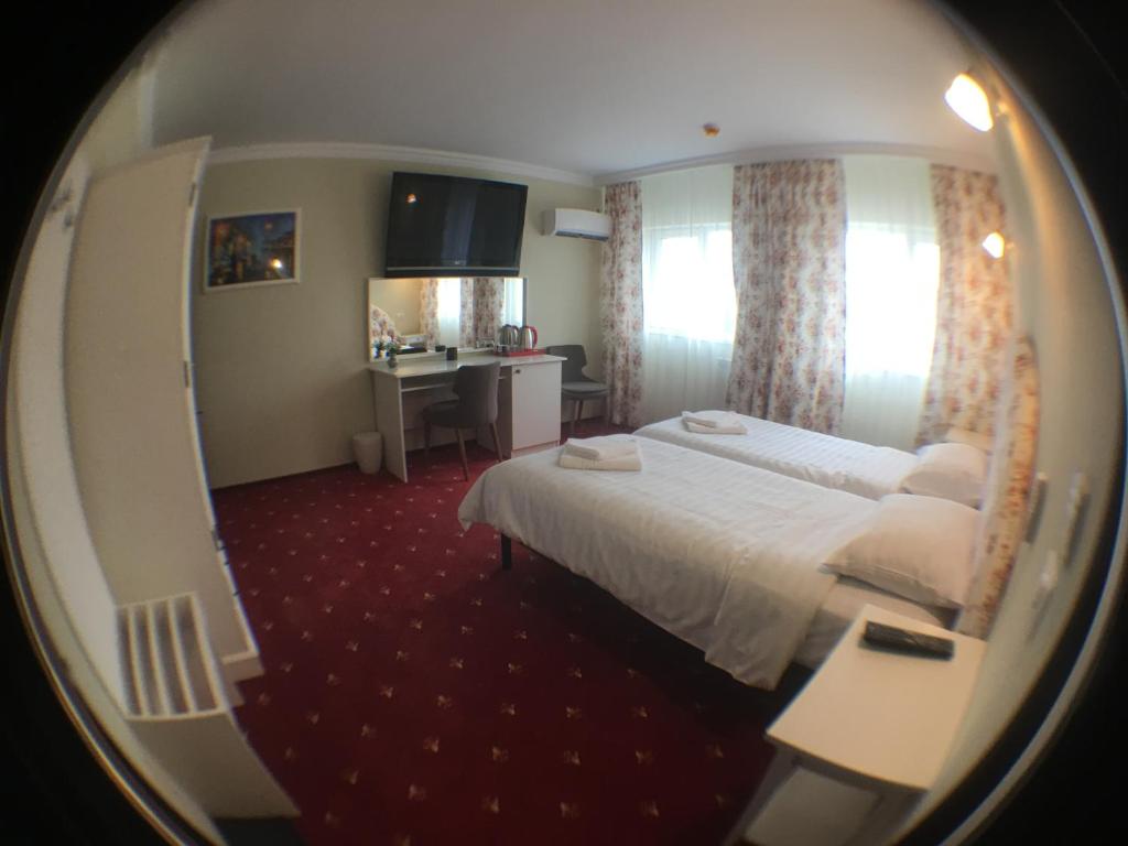 a hotel room with a bed and a desk at Casa Bucovineana in Suceava