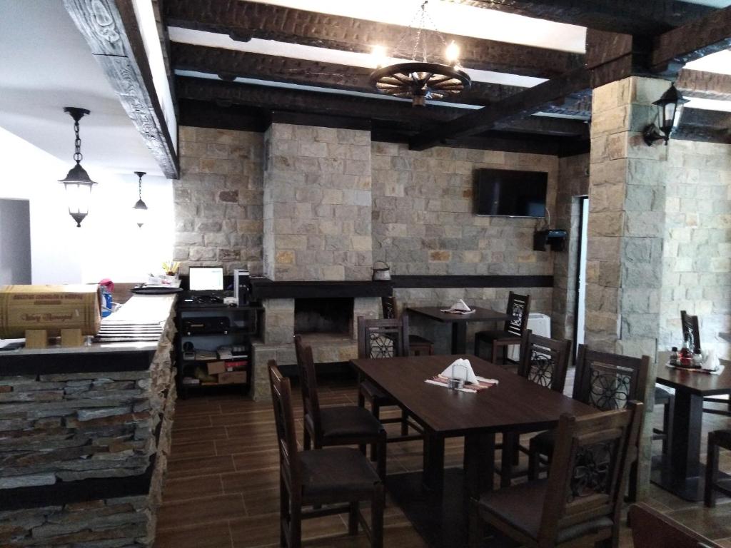 a dining room with a table and chairs and a counter at Complex Magic of the Rhodopes in Bachkovo