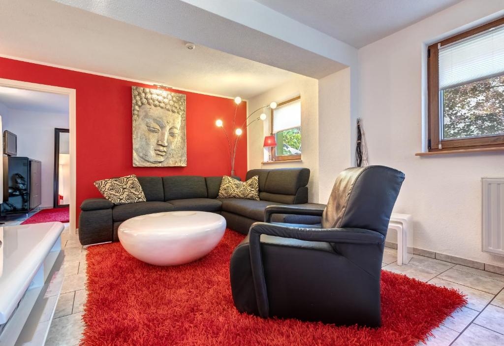 ein Wohnzimmer mit einem Sofa und einer roten Wand in der Unterkunft Ferienwohnung Kieferngrund in Ahlbeck