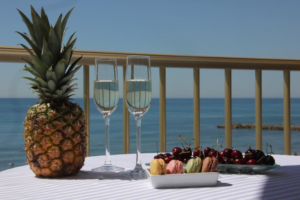 トレビエハにあるLa Playa Blanca 3, First line,Sea View, Beachのパイナップルとワイン2杯