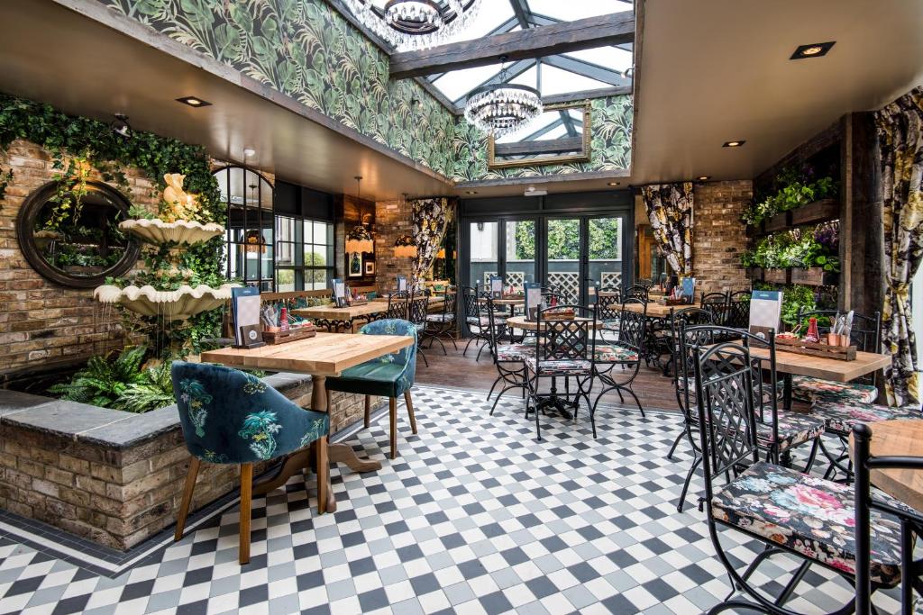 un restaurante con mesas y sillas y techo en The Seaton Lane Inn - The Inn Collection Group, en Seaham