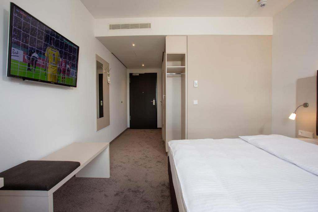 Postel nebo postele na pokoji v ubytování Hotel am Campus