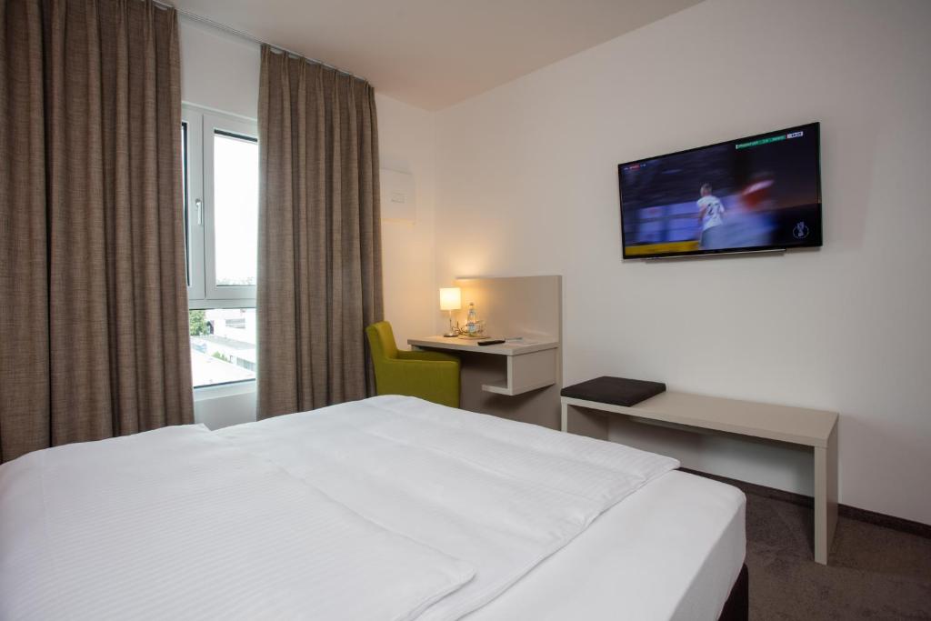 TV a/nebo společenská místnost v ubytování Hotel am Campus