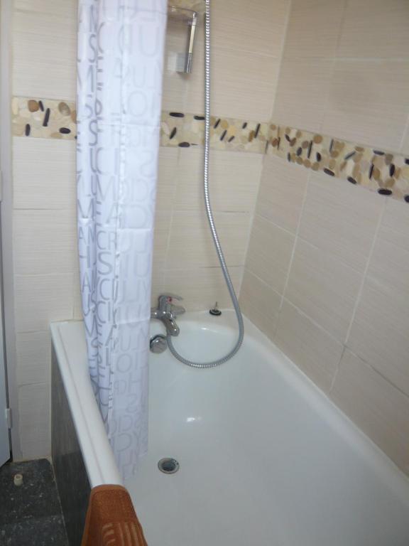 a bathroom with a shower with a white tub at Studio Centre Ville Office De Tourisme in Bayonne
