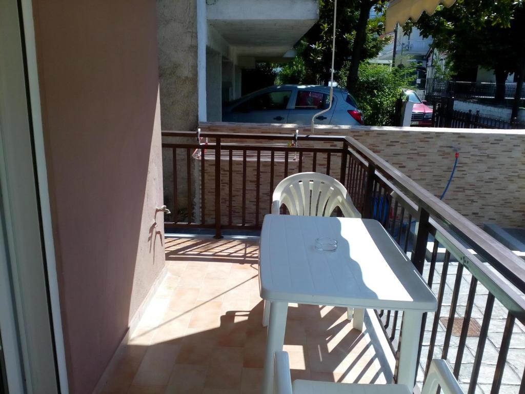 a white table and chair on a balcony at Anastasia Studios in Platamonas