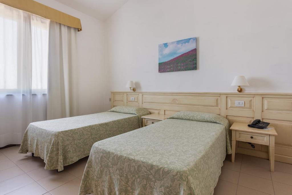 Postel nebo postele na pokoji v ubytování Rodia Inn