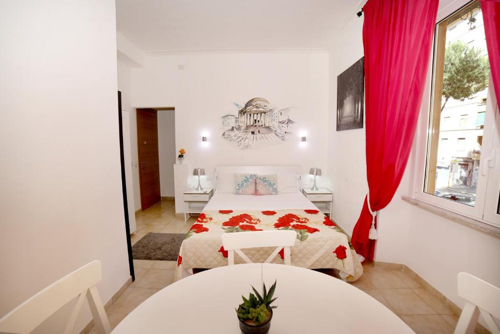 a white bedroom with a bed and two tables at Gateway Residence in Rome