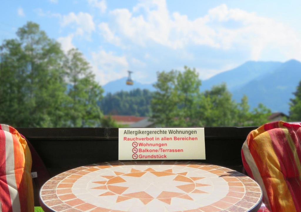 a table with a sign sitting on top of it at Ferienwohnungen Lind in Oberstdorf