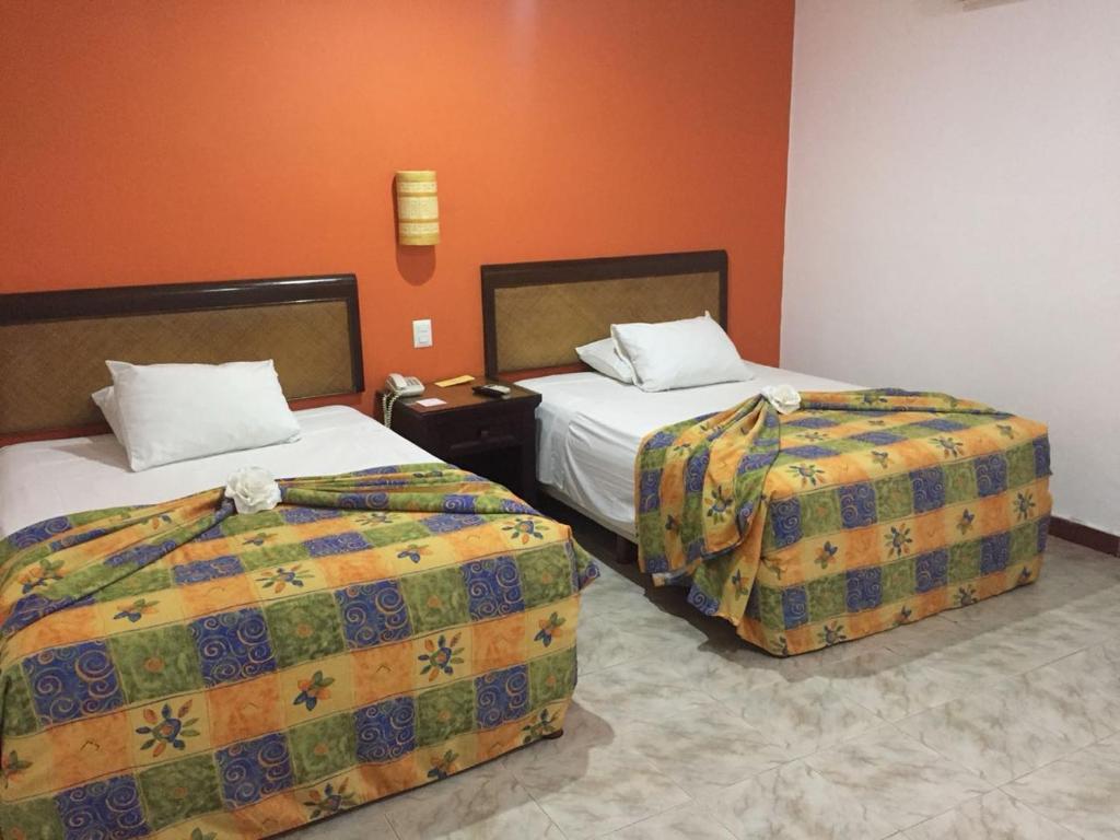 Postel nebo postele na pokoji v ubytování Hotel María Jose