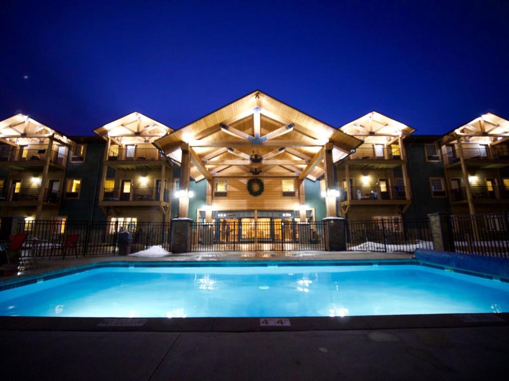 a swimming pool in front of a building at night at Caberfae Peaks Ski & Golf Resort in Harrietta