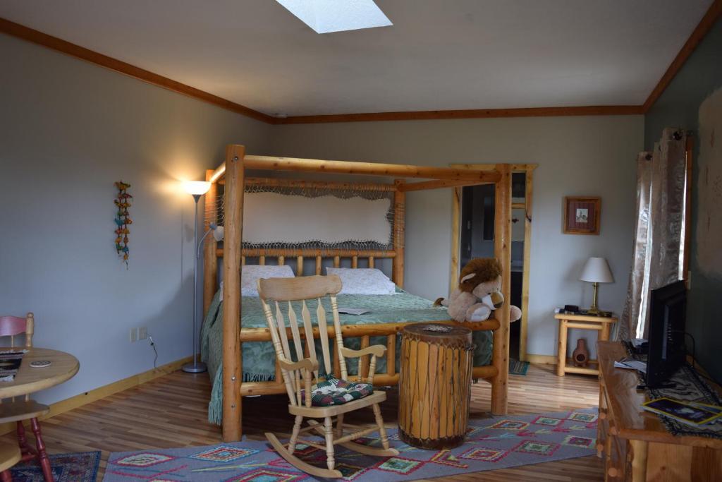a bedroom with a bunk bed and a chair at The Inn of Escalante in Escalante
