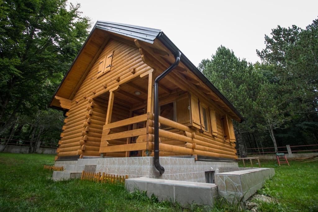 a wooden cabin in a field of grass at Cabin House Hidden Nest in Mostar
