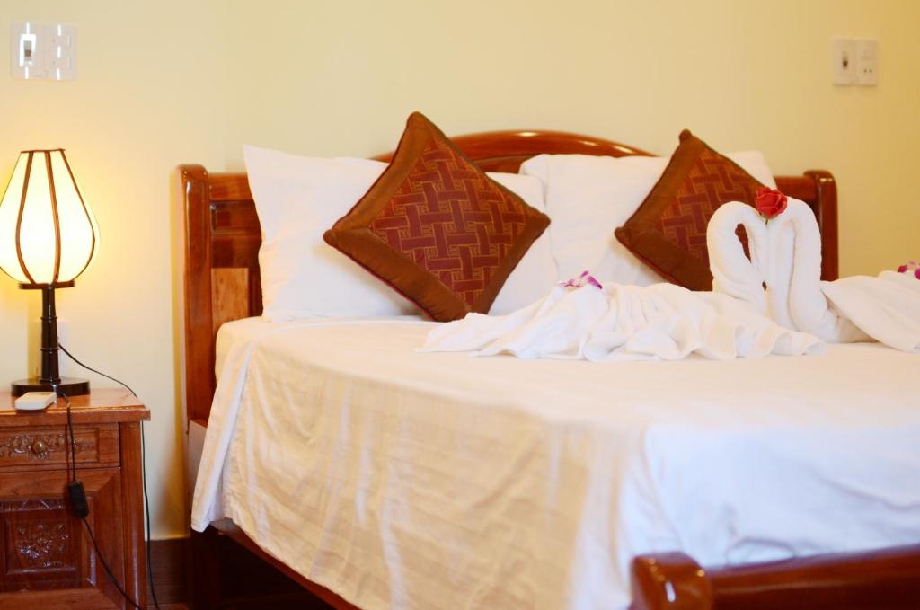 Postel nebo postele na pokoji v ubytování Panda Garden Homestay