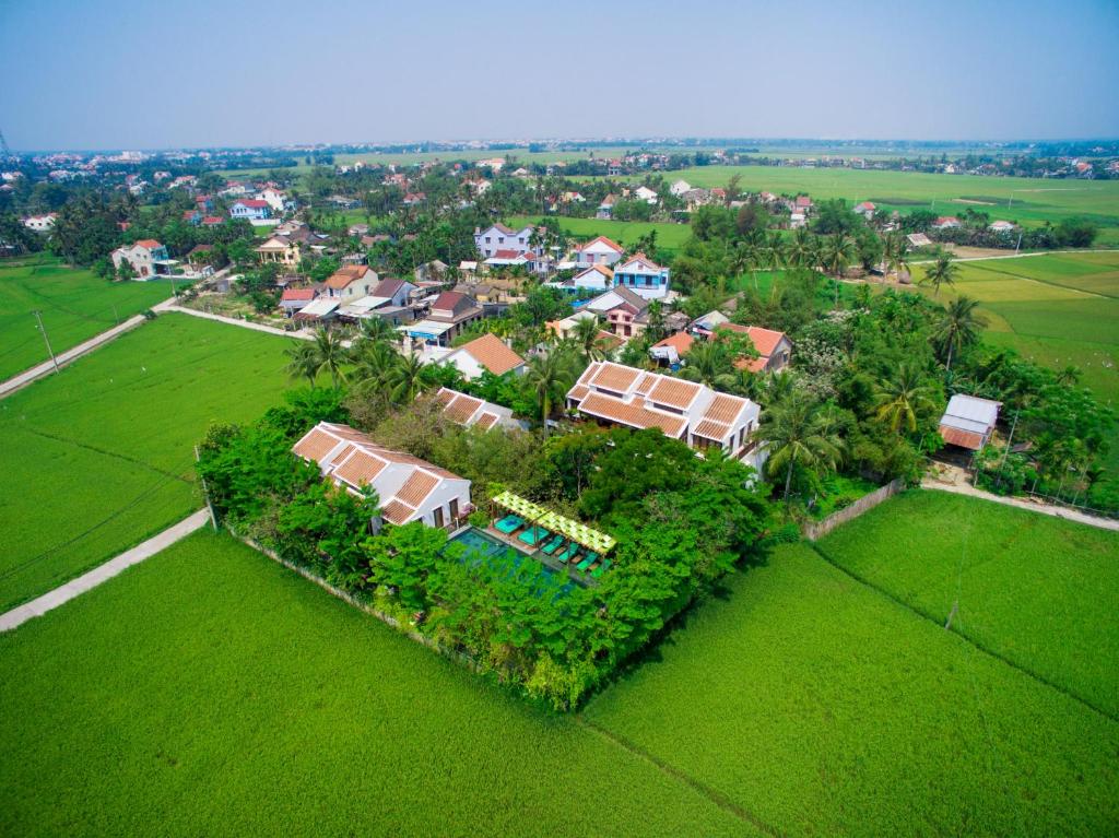 an aerial view of a house in a green field at Hoi An Chic - Green Retreat in Hoi An