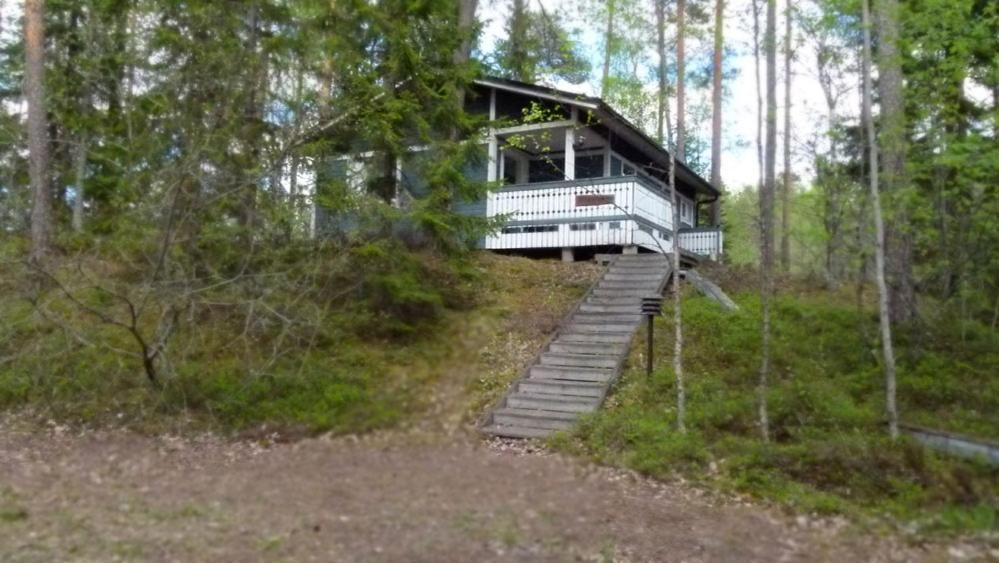 a tree house on a hill in the woods at Tikkamäki in Orivesi