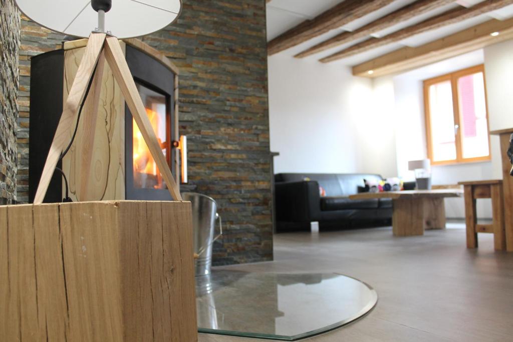 a living room with a fireplace and a table at Gite le 16 in Ribeauvillé