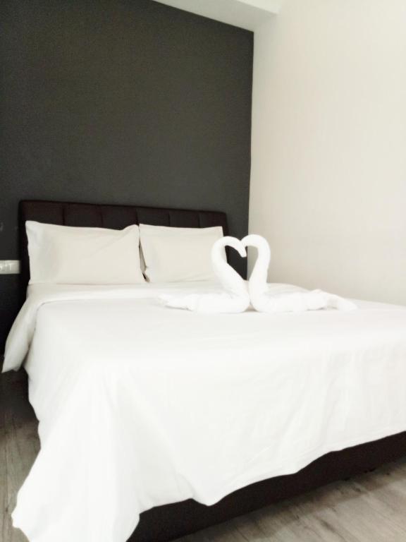 Postel nebo postele na pokoji v ubytování Sandy Hotel Malacca