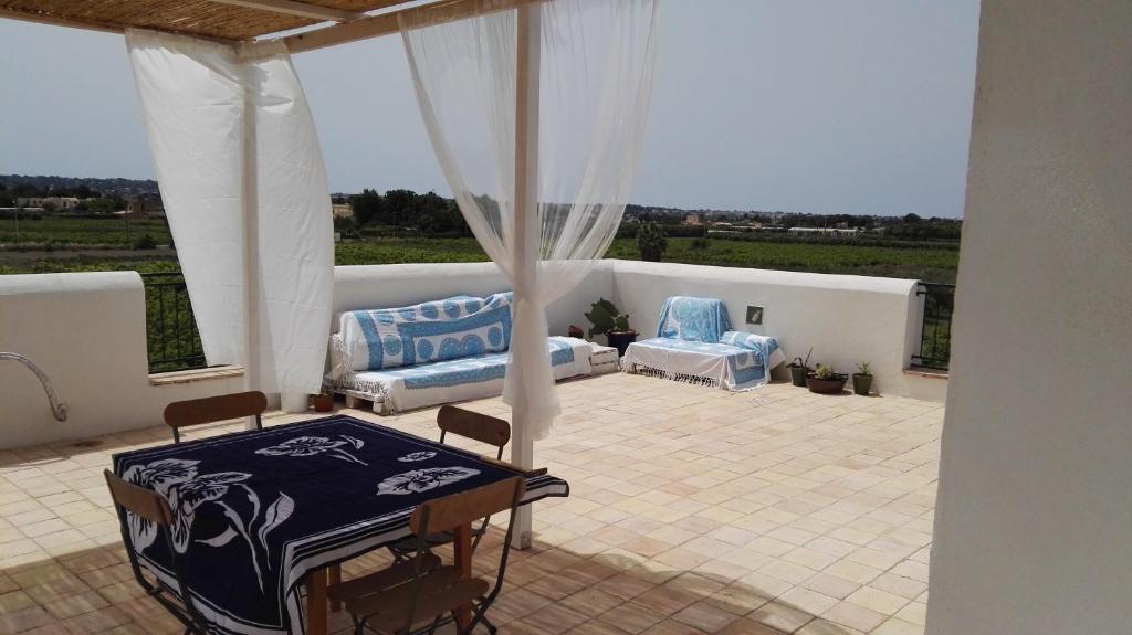 a patio with two chairs and a table on a patio at Residenza al Gelso in Marsala