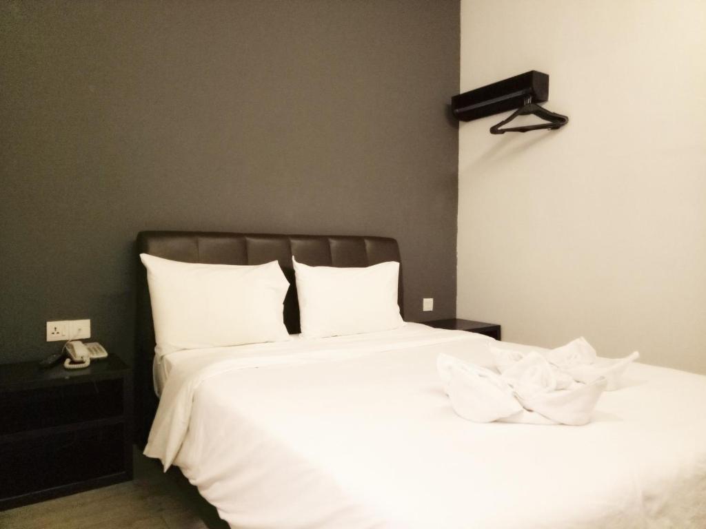 Postel nebo postele na pokoji v ubytování Sandy Hotel Malacca