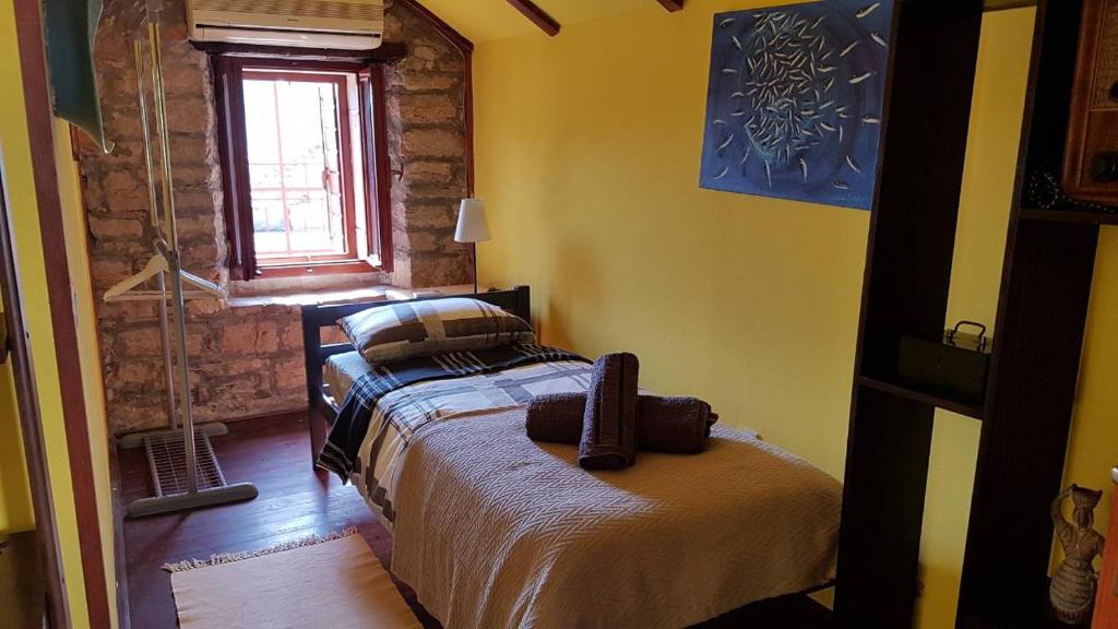 a bedroom with a bed and a window at Mama's & Papa's house in Vrboska
