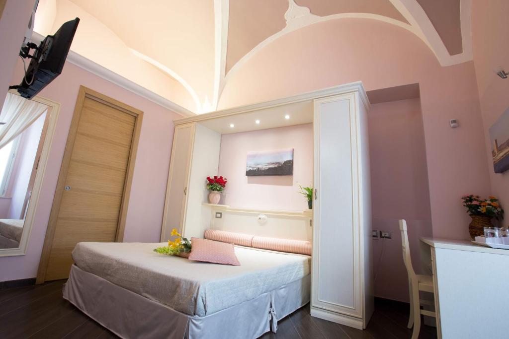 Postel nebo postele na pokoji v ubytování Relais Parallelo 41