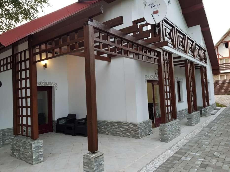 a building with awnings on the side of it at Cabana Vânătorilor din Valiug in Văliug