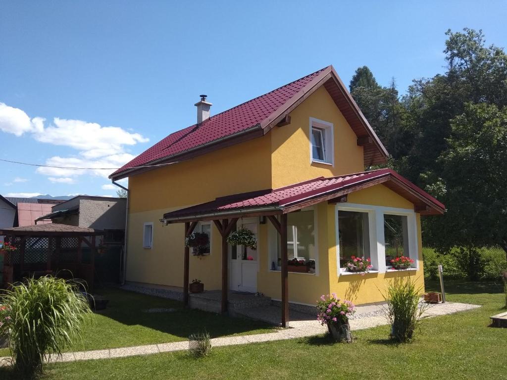 a yellow house with a red roof at Privat Em & Mi in Liptovský Mikuláš