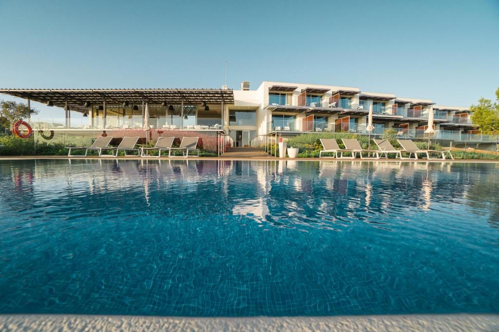 a large pool of water in front of a building at Palmares Beach House Hotel - Adults Only in Lagos