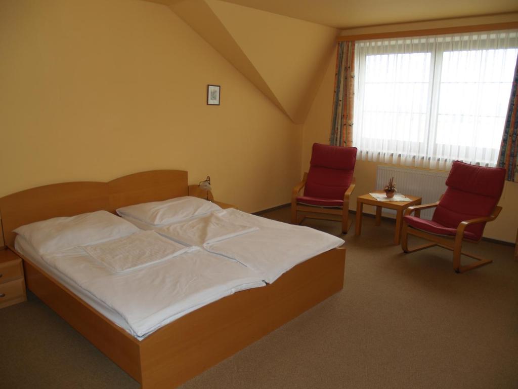 Postel nebo postele na pokoji v ubytování Motel U Krbu
