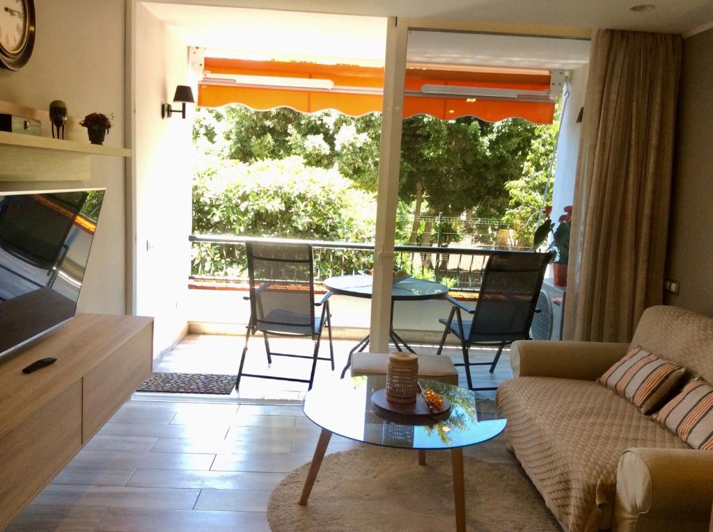a living room with a couch and a table at Torres del Sol in Playa de las Americas