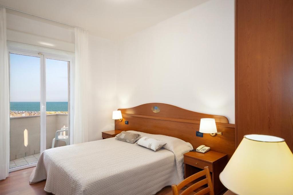Posteľ alebo postele v izbe v ubytovaní Hotel Delfino
