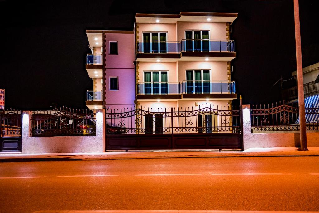a building on the side of a street at night at Apartments Krstovic in Sutomore