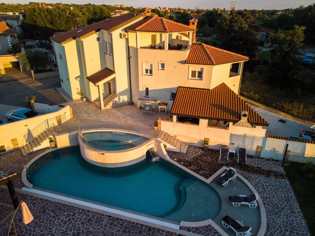 an aerial view of a house with a swimming pool at Amela in Pula
