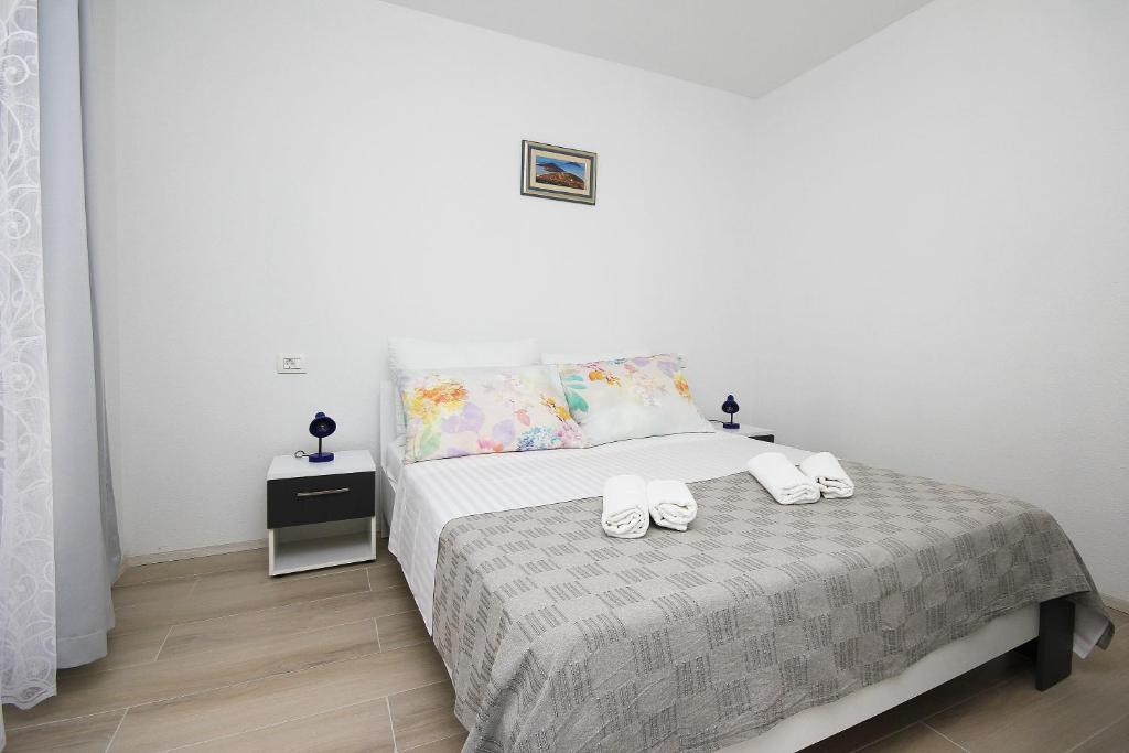 Posteľ alebo postele v izbe v ubytovaní Apartmani Lovre