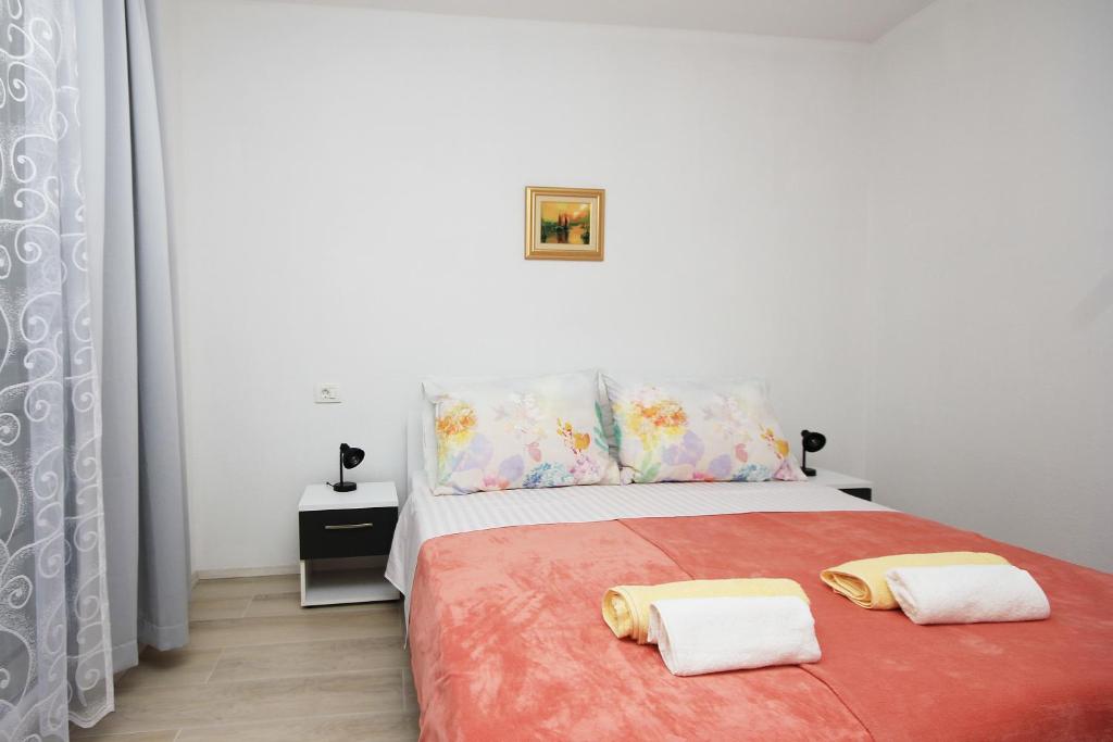 Posteľ alebo postele v izbe v ubytovaní Apartmani Lovre