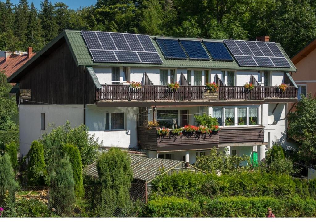 a house with solar panels on the roof at Aura in Szklarska Poręba