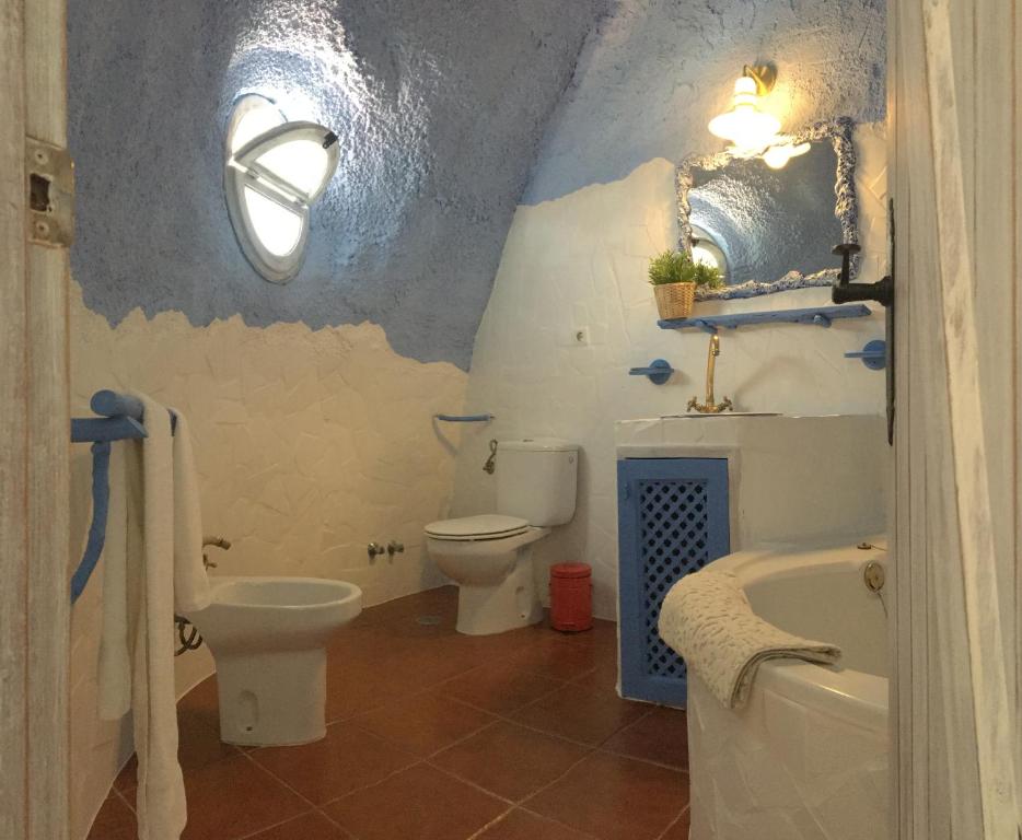 y baño con aseo, bañera y lavamanos. en Hotel Rural los Caracoles, en Frigiliana