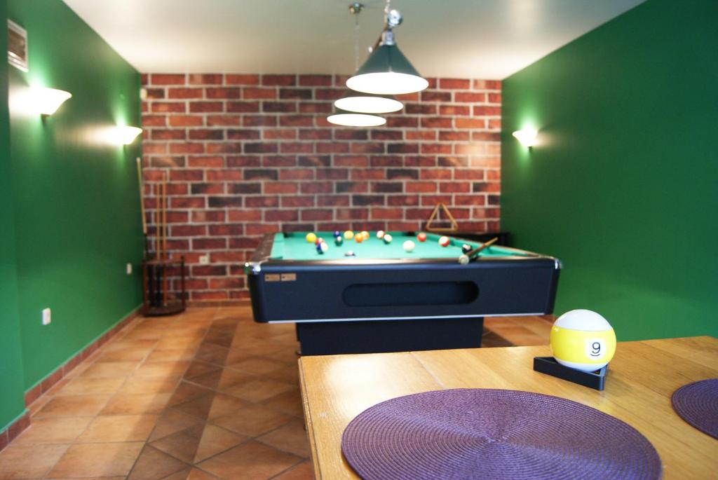 a room with a pool table and a brick wall at Family House Talani in Zagreb