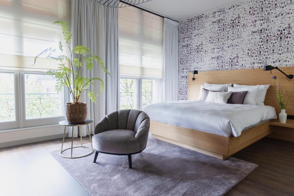 Een bed of bedden in een kamer bij Boutique Hotel Catshuis