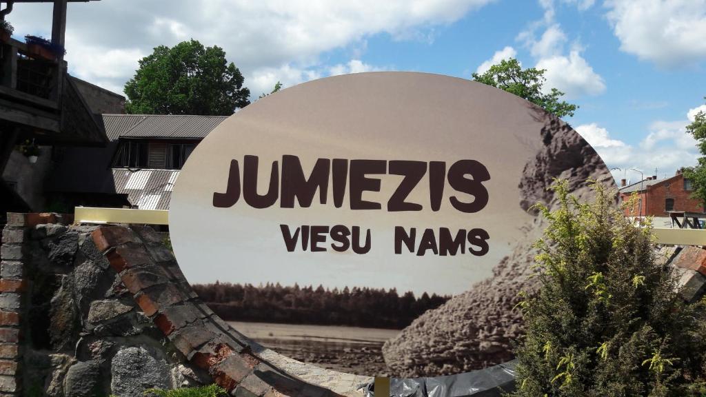 a sign for a jumeirah usvu kmhs company at Guest house Jumiezis in Pļaviņas