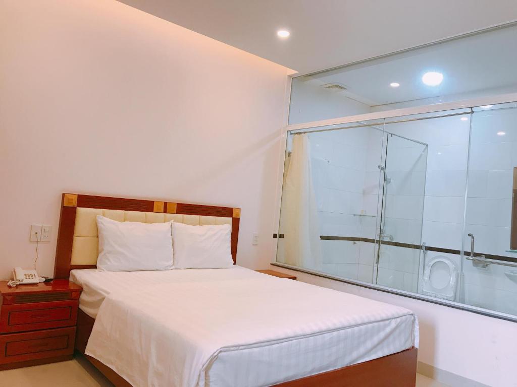 Un pat sau paturi într-o cameră la Hoang Ngoc Hotel