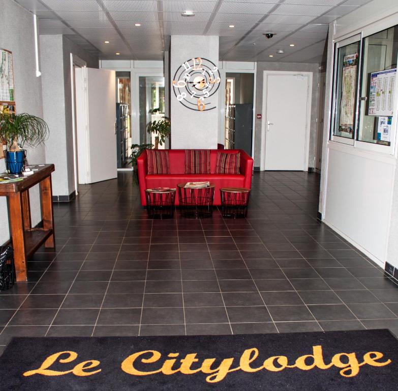a lobby with red chairs and a sign that saysilage at City Lodge Appart Hôtel Niort in Niort