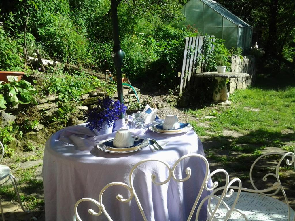 a table with a white table cloth on it at villatiffany in Torriglia