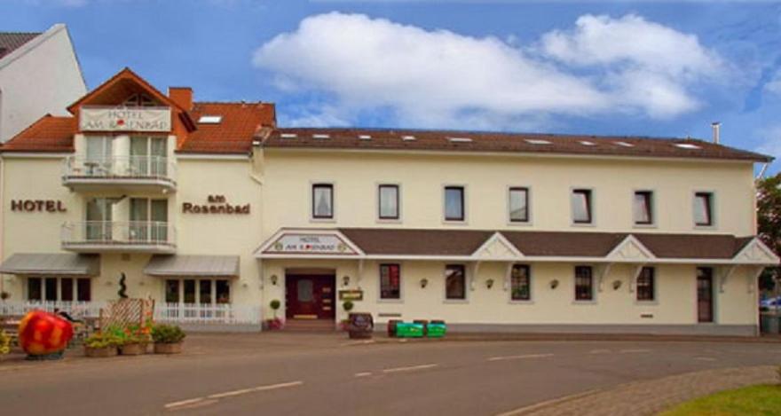 a large white building with a sign on it at Hotel am Rosenbad in Fulda
