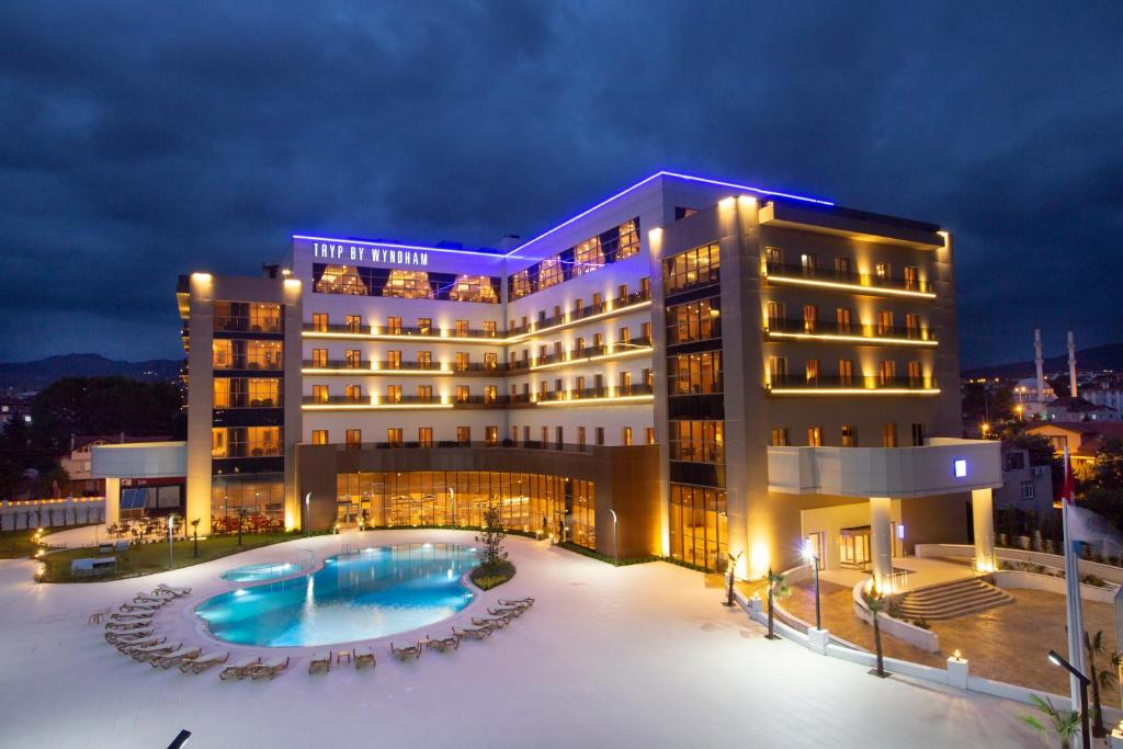 a hotel with a pool in front of a building at TRYP by Wyndham Izmit in Kocaeli